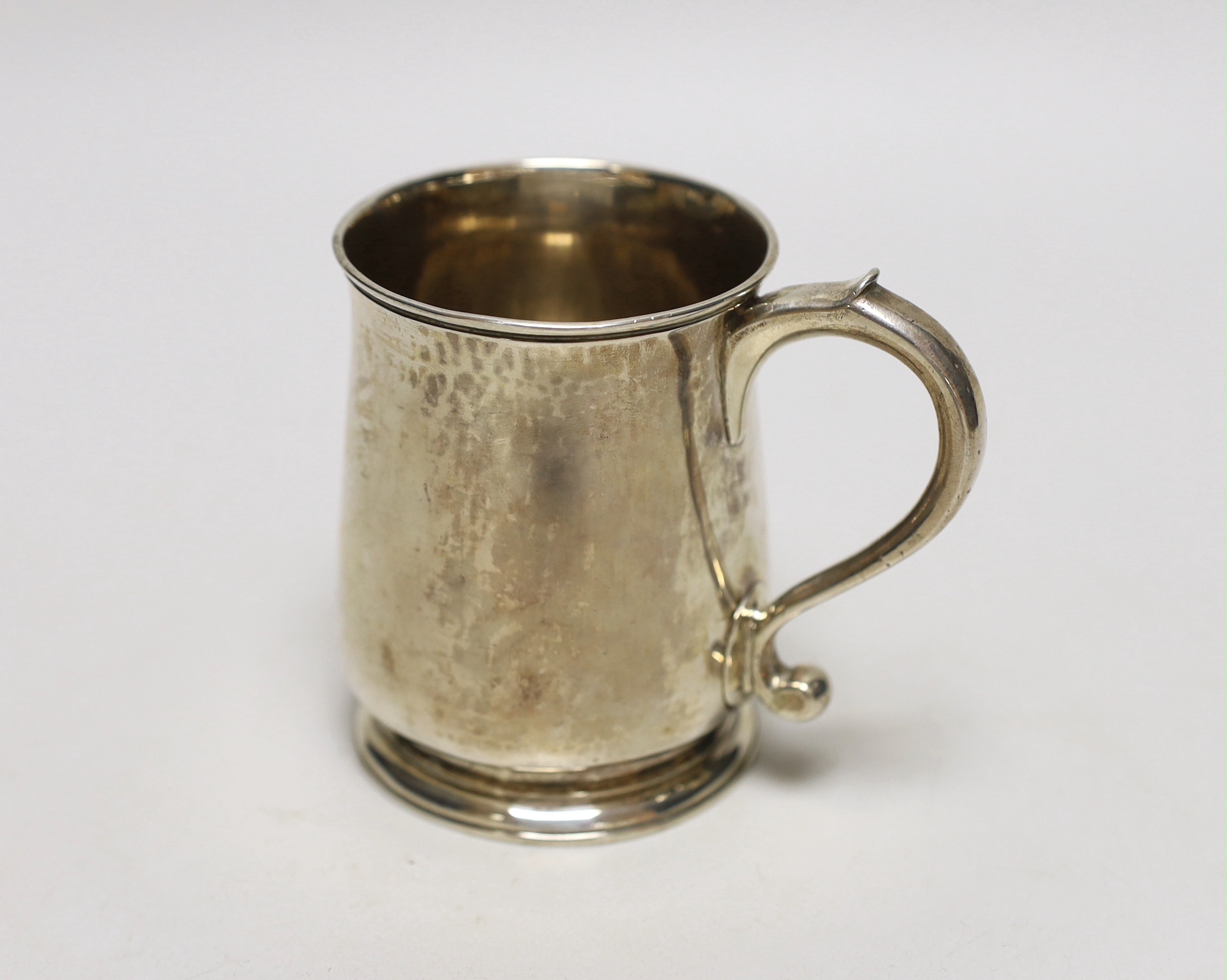 A George II silver half pint mug, engraved with a crest and the motto 'Beef and Liberty', makers mark rubbed, London 1730, 9.5cm, 194 grams